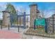 The entrance to Piedmont Park in Atlanta with stone pillars, iron gates, and manicured flower beds at 1598 W Sussex Rd, Atlanta, GA 30306