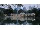 Scenic view of a building reflected in a pond, with a cityscape backdrop and lush greenery at 1598 W Sussex Rd, Atlanta, GA 30306