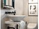 Stylish powder room features a vessel sink, modern fixtures, and textured wallpaper at 1598 W Sussex Rd, Atlanta, GA 30306