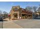 Stone clad exterior of Morningside Village featuring retail and restaurant businesses at 1598 W Sussex Rd, Atlanta, GA 30306