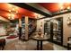 Wine cellar features wood flooring, dark trim, textured walls, a round table, and a display of wine bottles at 1598 W Sussex Rd, Atlanta, GA 30306