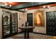 Wine cellar with dark trim, textured walls, a round table, and a display of wine bottles at 1598 W Sussex Rd, Atlanta, GA 30306