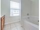 Bathroom featuring a corner bathtub and window at 53 Providence Oak Ct, Lawrenceville, GA 30046