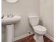 Simple half bathroom with white pedestal sink and toilet at 53 Providence Oak Ct, Lawrenceville, GA 30046