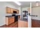 Kitchen with dark countertops and wood cabinets at 53 Providence Oak Ct, Lawrenceville, GA 30046