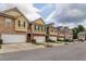 Exterior view of townhomes with attached garages and landscaping at 53 Providence Oak Ct, Lawrenceville, GA 30046