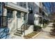 Street view of new construction townhomes featuring individual entry stairs and well-maintained landscaping at 711 Needletail Way, Atlanta, GA 30312