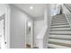 Hallway with stairs leading upwards, bathroom entrance, and a neutral color scheme at 711 Needletail Way, Atlanta, GA 30312