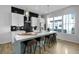 Modern kitchen with white cabinets, black backsplash, stainless steel appliances, and a large kitchen island at 711 Needletail Way, Atlanta, GA 30312