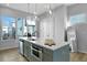 Bright kitchen boasts a gray island with stainless steel appliances and quartz countertop at 711 Needletail Way, Atlanta, GA 30312