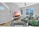 Contemporary living room with hardwood floors, ceiling fan, and a cozy seating arrangement at 711 Needletail Way, Atlanta, GA 30312