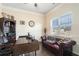 Home office with built-in shelving, hardwood floors, and a comfortable seating area at 105 Couch Ct, Fayetteville, GA 30214