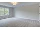 Well-lit bedroom with carpet and large window at 163 Bluffington Way, Marietta, GA 30066