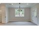 Spacious dining area with hardwood floors, a chandelier, and a view of the backyard at 163 Bluffington Way, Marietta, GA 30066