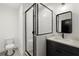 Modern bathroom with a frameless shower, dark vanity, and matte black fixtures at 2335 Mason Dr # D27, Atlanta, GA 30316