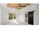 Main bedroom with tray ceiling, ceiling fan, and barn door to en-suite at 2335 Mason Dr # D27, Atlanta, GA 30316