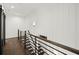 Upstairs hallway with a modern metal railing and wainscoting at 2335 Mason Dr # D27, Atlanta, GA 30316