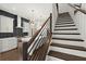 Modern staircase with dark wood steps and metal railing, kitchen view at 2335 Mason Dr # D27, Atlanta, GA 30316