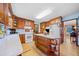 Eat-in kitchen with island, wood cabinets and view into dining area at 5321 Lanford Springs Sw Ct, Lilburn, GA 30047