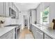 Stylish kitchen with gray cabinets, white backsplash and stainless steel appliances at 609 Old Wheat Ne St, Atlanta, GA 30312