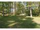 Spacious backyard with large shed and mature trees providing shade and privacy at 2690 Old Hickory Nw Dr, Marietta, GA 30064