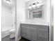 Well-lit bathroom with a gray vanity, updated fixtures, and a shower-tub combination, offering a spa-like experience at 2690 Old Hickory Nw Dr, Marietta, GA 30064