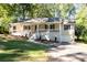 Charming ranch-style home features a welcoming front porch and a well-maintained front yard with mature trees at 2690 Old Hickory Nw Dr, Marietta, GA 30064