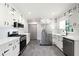 Bright kitchen with stainless steel appliances, white cabinets, gray tile floor, and modern finishes at 2690 Old Hickory Nw Dr, Marietta, GA 30064