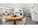 Open kitchen and dining area featuring stainless steel appliances, white cabinetry, and an adjacent living space at 2690 Old Hickory Nw Dr, Marietta, GA 30064