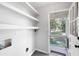 Laundry room features built-in shelving, tile floors, and access to the porch at 2690 Old Hickory Nw Dr, Marietta, GA 30064