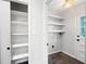 Bright laundry room with built-in shelving and a door leading outside at 2690 Old Hickory Nw Dr, Marietta, GA 30064
