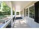 Spacious covered porch with white railings and black shutters offers shade and style at 2690 Old Hickory Nw Dr, Marietta, GA 30064