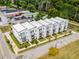 Stunning aerial view of modern townhomes in a vibrant neighborhood, surrounded by mature trees and sidewalks at 3072 Kelly St, Scottdale, GA 30079