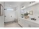 Bright bathroom featuring a glass shower with a built-in bench and double sink vanity at 3072 Kelly St, Scottdale, GA 30079