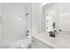 Contemporary bathroom features white subway tile, a bathtub, and a stylish sink with vanity at 3072 Kelly St, Scottdale, GA 30079