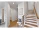 Inviting hallway with wood floors, a staircase, and a comfortable chair at 3072 Kelly St, Scottdale, GA 30079