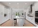 Bright and open kitchen featuring white cabinetry, stainless steel appliances, and a kitchen island with seating at 3072 Kelly St, Scottdale, GA 30079