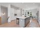 Modern kitchen with stainless steel appliances, white cabinets, and island seating adjacent to the dining area at 3072 Kelly St, Scottdale, GA 30079