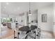 Bright living room with modern dining table, island seating, and stainless steel appliances at 3072 Kelly St, Scottdale, GA 30079