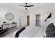 Bright main bedroom featuring a ceiling fan, a walk-in closet, and an ensuite bathroom at 3072 Kelly St, Scottdale, GA 30079