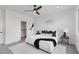 Bright main bedroom featuring a ceiling fan, carpet floors, and a walk-in closet at 3072 Kelly St, Scottdale, GA 30079