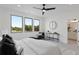 Bright main bedroom featuring a ceiling fan, three large windows, and an ensuite bathroom at 3072 Kelly St, Scottdale, GA 30079