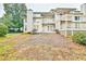 Townhouse back exterior features a spacious deck, steps leading to a patio, and mature landscaping at 4083 Audubon Dr, Marietta, GA 30068