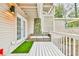 Private deck with a comfortable three-seater couch and artificial turf at 4083 Audubon Dr, Marietta, GA 30068