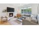 Spacious living room with a fireplace, large windows, and ample natural light at 416 Glen Iris Ne Dr, Atlanta, GA 30308