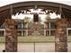 Framed view of an amphitheater with stone pillars, outdoor seating and commercial buildings at 519 Godfrey Dr, Cumming, GA 30040