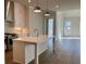 Modern kitchen with quartz island, stainless steel appliances and gold pendant lighting at 519 Godfrey Dr, Cumming, GA 30040