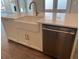 Kitchen island with farmhouse sink, dishwasher, and quartz countertop at 519 Godfrey Dr, Cumming, GA 30040