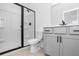 Modern bathroom with walk-in shower, stylish vanity, and tiled floors at 6210 Misty Hill Ln, Buford, GA 30518