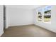 Bright bedroom featuring light hardwood flooring, neutral paint, base molding, and large windows at 6210 Misty Hill Ln, Buford, GA 30518